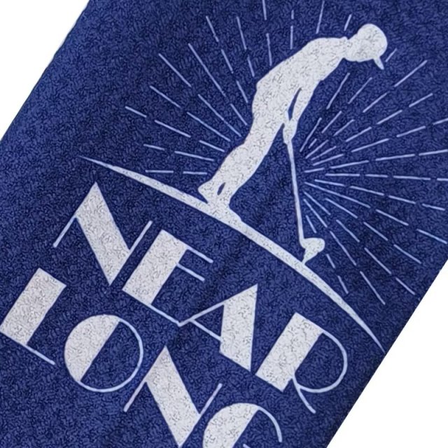 Custom golf towel with Near Long golfer logo on navy surface