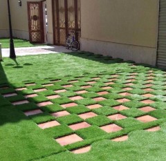 Detail of the reinforced permeable backing on decorative leisure artificial grass.