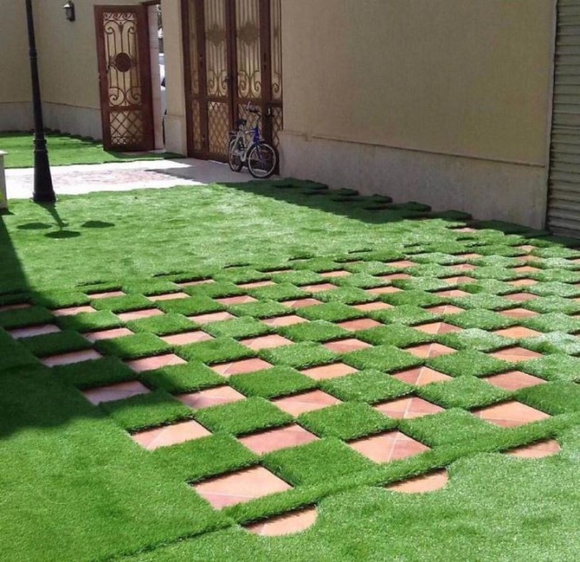 Detail of the reinforced permeable backing on decorative leisure artificial grass.