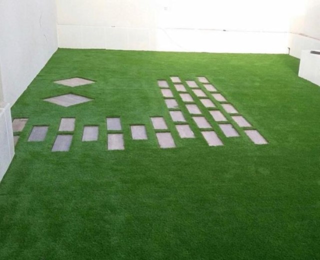 Low-profile decorative artificial grass carpet for urban balcony and terrace decor.