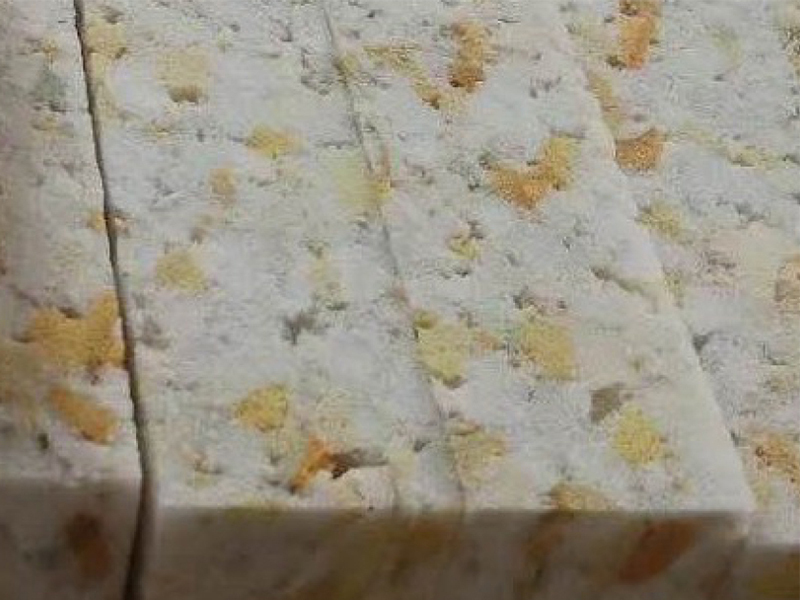 Raw waste industrial sponge scraps being prepared for the rebonding process.