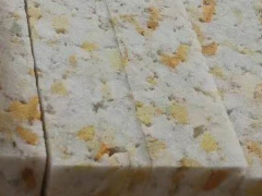 Raw waste industrial sponge scraps being prepared for the rebonding process.