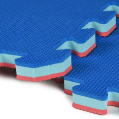 Interlocking puzzle edges of 3/4 inch foam mats being assembled for a home gym.