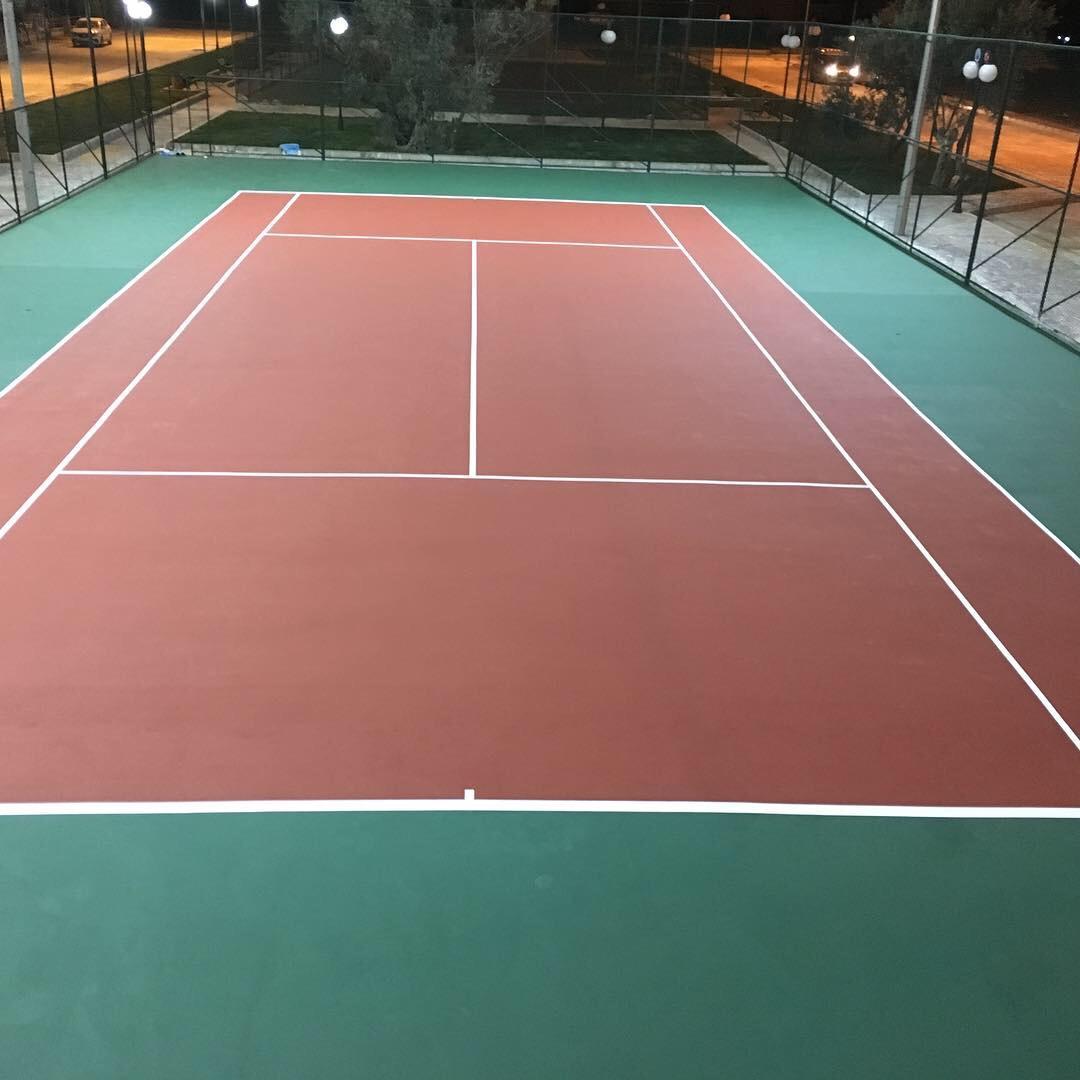 Professional basketball court markings on a vibrant blue acrylic sport floor surface.