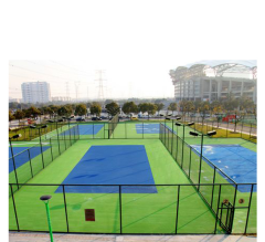 Seamless acrylic sport flooring being installed over a durable asphalt sub-base.