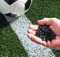 Close-up of high-resilience black SBR crumb rubber granules for athletic track surfacing.