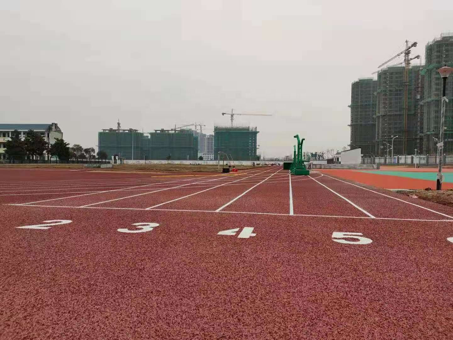 Demonstration of shock-absorbent rubber fitness tiles for high-impact sports protection.