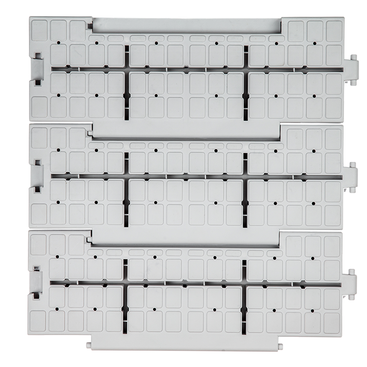Close-up of the anti-slip surface and drainage holes of PP event tiles.