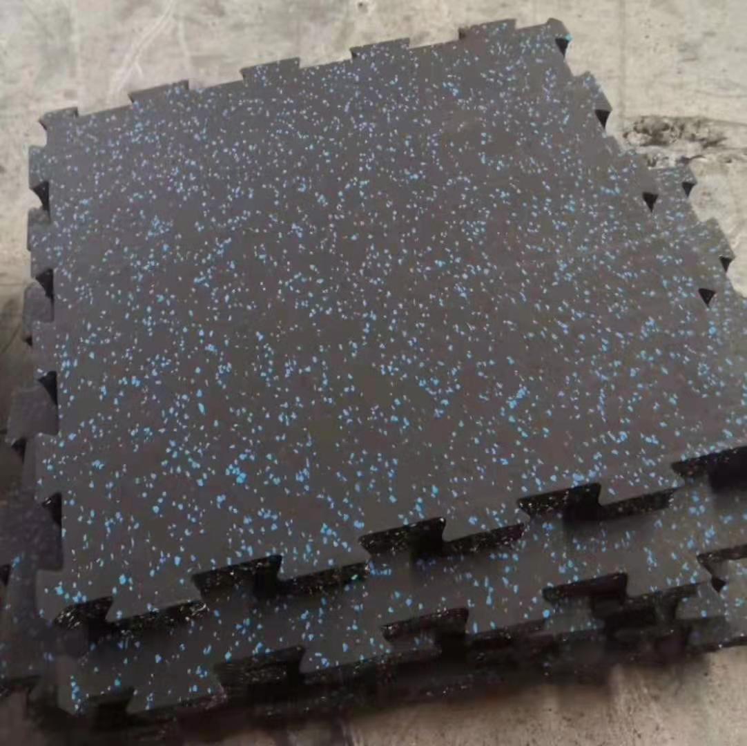 Seamless installation of high-density interlocking rubber mats in a professional fitness center.