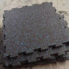 Seamless installation of high-density interlocking rubber mats in a professional fitness center.