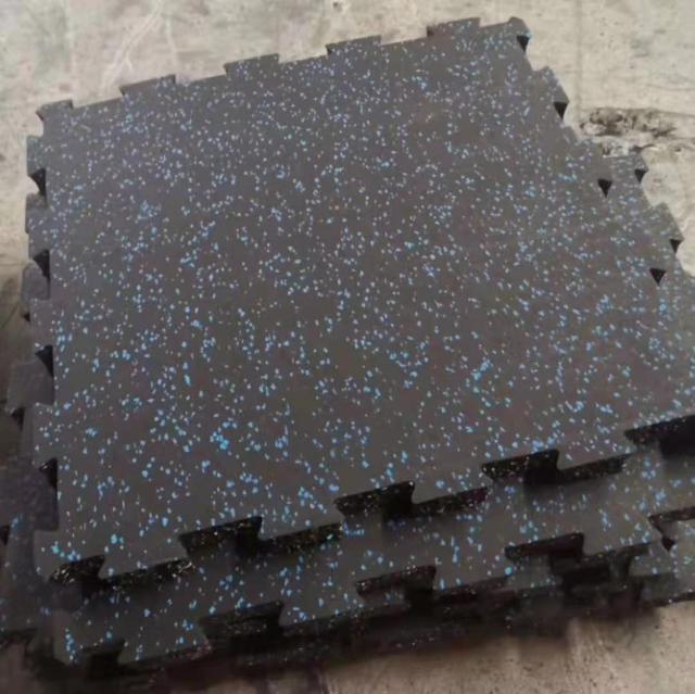 Seamless installation of high-density interlocking rubber mats in a professional fitness center.