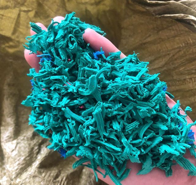 Close-up of 6-30 mesh EPDM rubber granules for sports field and playground application.