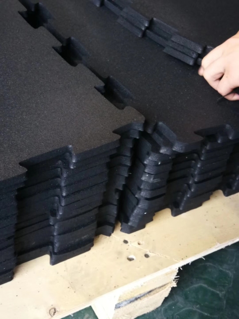 Non-slip and wear-resistant rubber flooring used in a high-traffic professional weight room.