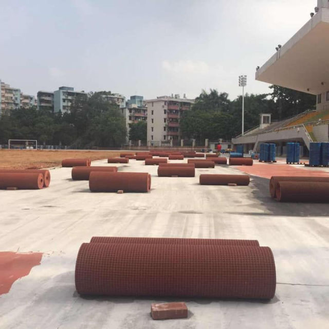 Prefabricated rubber running track material in a roll for easy transport and construction.