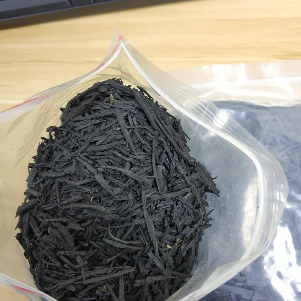 Close-up of UV-resistant shredded SBR rubber mulch showing its durable and porous texture.
