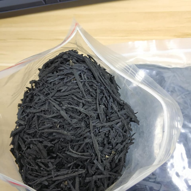 Close-up of UV-resistant shredded SBR rubber mulch showing its durable and porous texture.