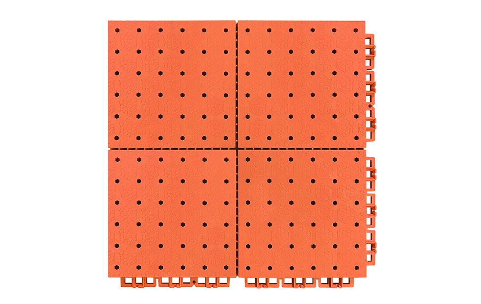 Underside view of a 305×305×13mm TPR sports flooring tile showing the dense reinforced support feet grid and hexagonal drainage hole exits, demonstrating the load distribution and vertical drainage path of the modular thermoplastic rubber tile structure.