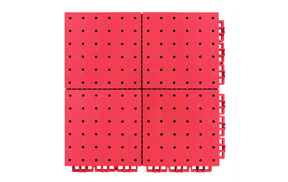 Close-up of the reinforced interlocking perimeter joint and small grid soft connection design on a 305×305mm thermoplastic rubber sports tile, showing the flexible joint geometry that accommodates thermal expansion and contraction in large outdoor sports surface installations.