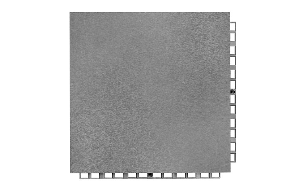 Underside view of a 305×305×16mm TPR indoor court sports flooring tile showing the octagonal bottom support structure, which distributes player impact and fall loading evenly across the subfloor surface for volleyball, basketball, futsal, and bowling facility installations.