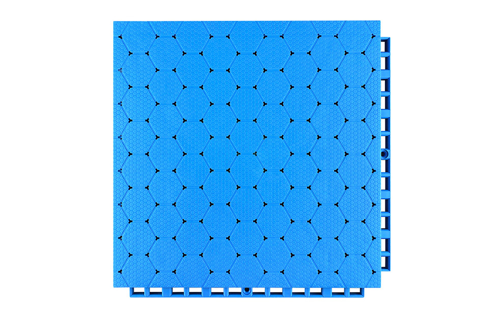 Underside view of a 305×305×16mm TPR sports flooring tile showing the octagonal bottom support structure and integrated two-way drainage channel geometry, illustrating the load distribution footprint and bidirectional water runoff path for outdoor sports surface installation.