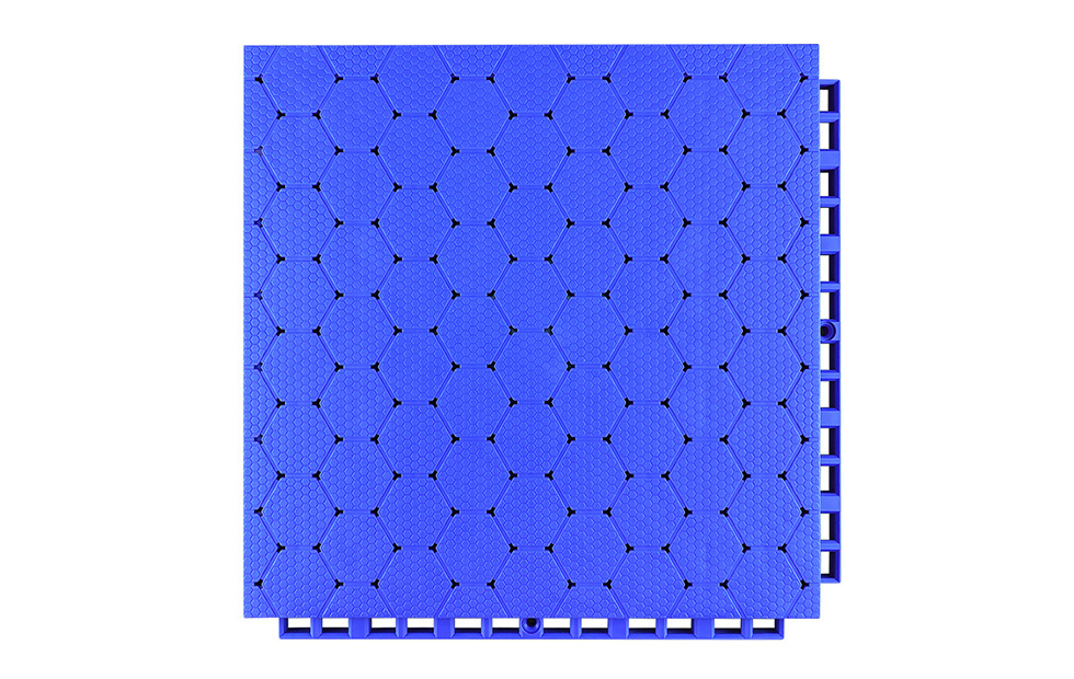 Close-up of the dense interlocking connection perimeter joint on a 305×305×16mm thermoplastic rubber sports tile, showing the locking geometry that secures adjacent panels in planar alignment without adhesive or mechanical fasteners for school and fitness facility sports surface installations.