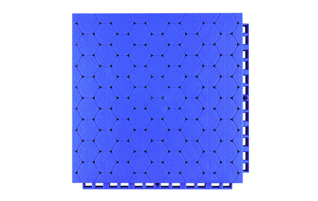 Close-up of the dense interlocking connection perimeter joint on a 305×305×16mm thermoplastic rubber sports tile, showing the locking geometry that secures adjacent panels in planar alignment without adhesive or mechanical fasteners for school and fitness facility sports surface installations.