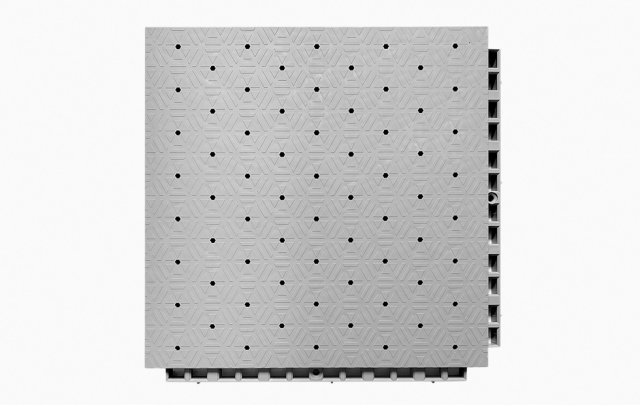 Angled underside and profile view of a 305×305×21mm TPR sports flooring tile showing the octagonal ring-shaped base geometry and reinforced support corners of the dense interlocking connection system, illustrating the shock distribution structure and connection alignment mechanism for professional sports venue installation.