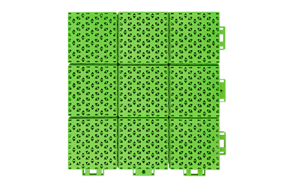 Close-up of the soft connection design perimeter joint between two adjacent 305×305×16mm double-layer hexagonal PP playground tiles, showing the compliant connection geometry that accommodates thermal expansion and substrate irregularity without joint separation in outdoor school playground installations.