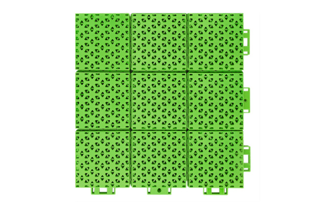 Close-up of the soft connection design perimeter joint between two adjacent 305×305×16mm double-layer hexagonal PP playground tiles, showing the compliant connection geometry that accommodates thermal expansion and substrate irregularity without joint separation in outdoor school playground installations.
