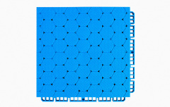 Underside view of a 250×250×16mm TPR sports tile showing the octagonal bottom support structure and two-way drainage channel geometry, which distributes vertical load across the substrate and facilitates rapid water runoff on installed outdoor sports surfaces.