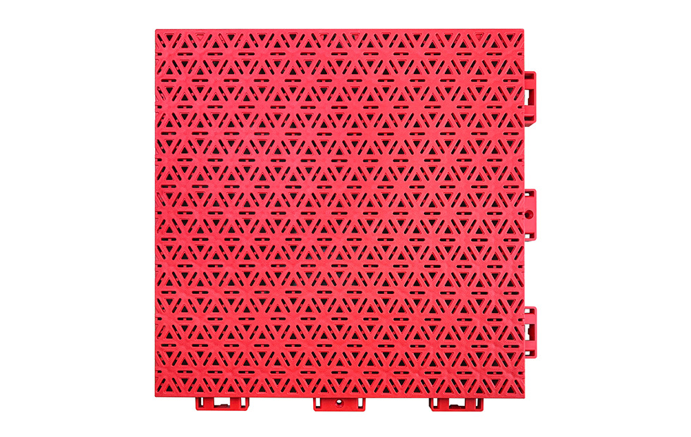 Close-up of the four-point injection molding lock structure connection joint on a 319×319×16mm three-layer hexagonal PP playground tile, showing the dimensionally consistent interlocking perimeter geometry produced by the four-point injection molding process for large-area school playground installations.