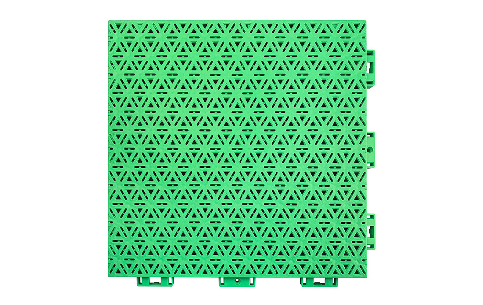 Installed 319×319×16mm three-layer hexagonal polypropylene interlocking playground tiles on an outdoor primary school or kindergarten playground surface, showing full-coverage modular installation, consistent pearl pattern matte texture, and uniform four-point injection lock joint alignment across the installed area.