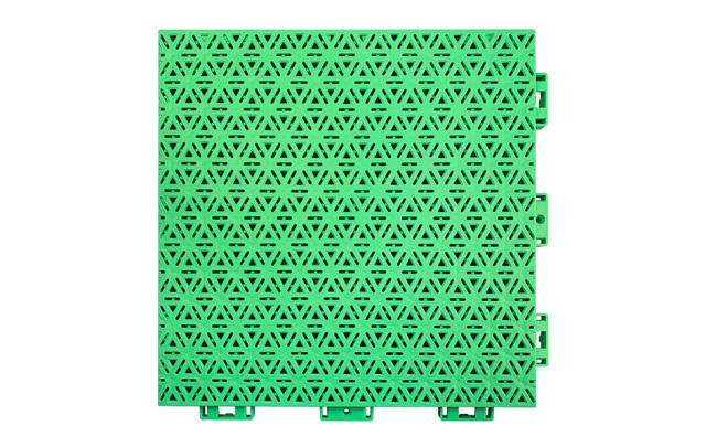 Installed 319×319×16mm three-layer hexagonal polypropylene interlocking playground tiles on an outdoor primary school or kindergarten playground surface, showing full-coverage modular installation, consistent pearl pattern matte texture, and uniform four-point injection lock joint alignment across the installed area.