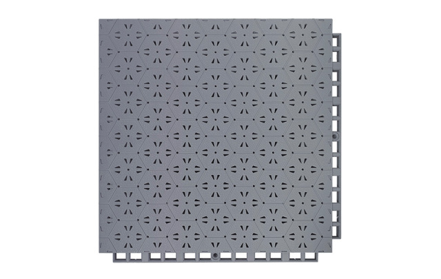 Installed 305×305×14mm thermoplastic rubber safety flooring tiles on an outdoor dual-use surface serving a sports field and kindergarten activity area, showing the patchwork thermal expansion joint design between adjacent tiles, uniform family hexagonal surface texture, and consistent tile alignment across the installed area.