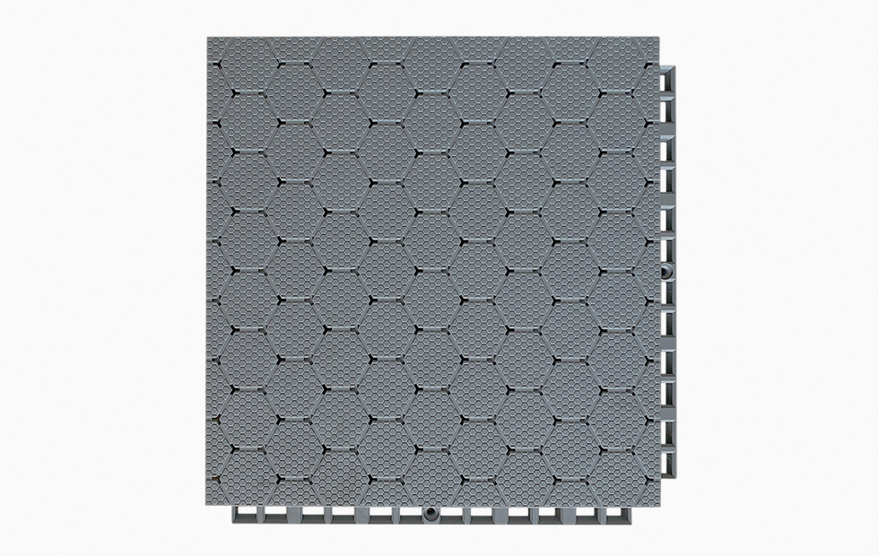 Top-down view of a 305×305×21mm TPV soft elastic sports flooring tile showing the thickened hexagonal dark pattern surface texture and the large flat soft material surface layer, designed for anti-slip grip and fall protection performance in professional school, college, and competition sports venue installations.