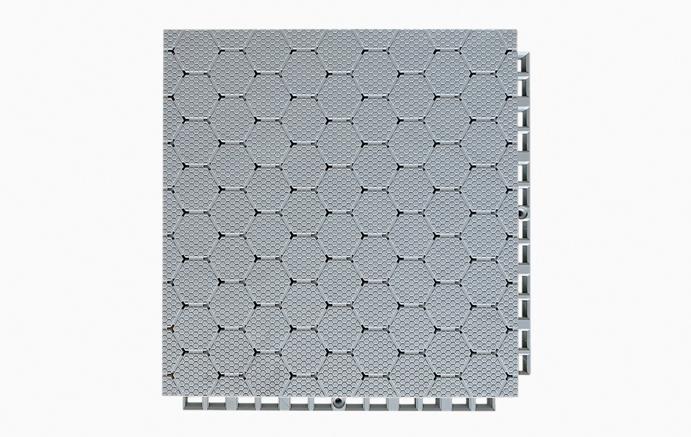 Angled profile and underside view of a 305×305×21mm TPV soft elastic sports flooring tile showing the octagonal ring-shaped base geometry and reinforced support corners of the dense interlocking connection system, illustrating the two-stage fall attenuation structure and inter-tile alignment mechanism for professional sports venue use.