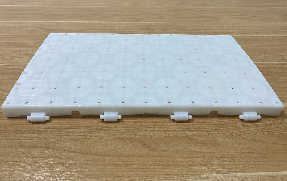 Close-up of the shaft snap joint and concealed groove design connection mechanism between two adjacent light-permeable PP lawn protection event flooring tiles, showing the recessed joint profile that keeps snap joints unexposed at the surface for trip-free event flooring and protected connection integrity under crowd and equipment loading.