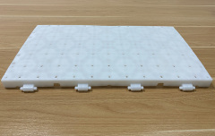 Close-up of the shaft snap joint and concealed groove design connection mechanism between two adjacent light-permeable PP lawn protection event flooring tiles, showing the recessed joint profile that keeps snap joints unexposed at the surface for trip-free event flooring and protected connection integrity under crowd and equipment loading.