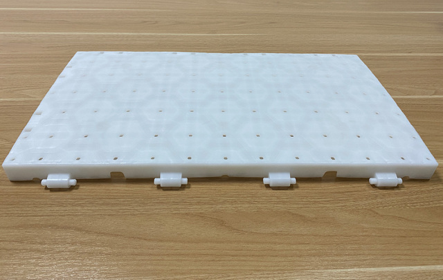 Close-up of the shaft snap joint and concealed groove design connection mechanism between two adjacent light-permeable PP lawn protection event flooring tiles, showing the recessed joint profile that keeps snap joints unexposed at the surface for trip-free event flooring and protected connection integrity under crowd and equipment loading.