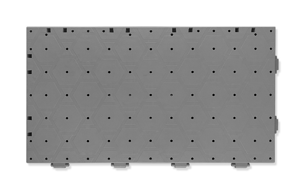 Underside view of a 60×33×3cm load-bearing PP interlocking lawn protection event flooring tile showing the hexagonal structure support at the bottom, enlarged base space, and air holes that distribute bearing loads across the tile footprint and maintain turf air permeability and moisture retention during temporary event coverage, conforming to GB/T 24508-2020.