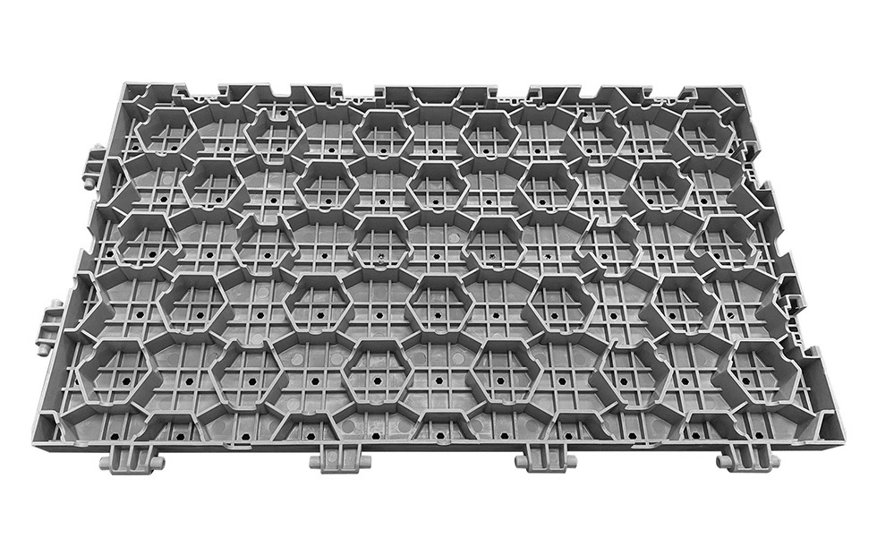 Installed 60×33×3cm load-bearing PP interlocking lawn protection event flooring tiles covering an outdoor sports center or festival venue grass surface, showing full modular coverage, flush concealed joint surface, and the temporary event flooring configuration rated at greater than 15 tons per square meter bearing capacity, conforming to GB/T 24508-2020 standard.