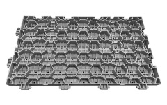 Installed 60×33×3cm load-bearing PP interlocking lawn protection event flooring tiles covering an outdoor sports center or festival venue grass surface, showing full modular coverage, flush concealed joint surface, and the temporary event flooring configuration rated at greater than 15 tons per square meter bearing capacity, conforming to GB/T 24508-2020 standard.