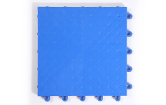 Installed 305×305×13mm PP rubber composite indoor sports tiles on an indoor basketball or multi-court sports venue floor, showing the precise interlocking connection joint alignment, consistent solid PP surface texture, and full-coverage modular installation with elastic rubber base layer visible at the tile perimeter.
