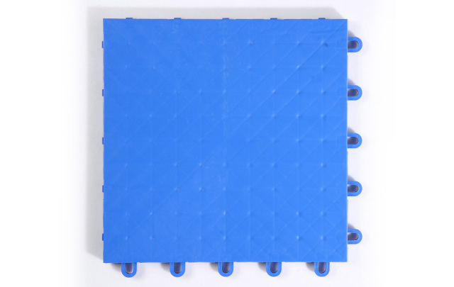 Installed 305×305×13mm PP rubber composite indoor sports tiles on an indoor basketball or multi-court sports venue floor, showing the precise interlocking connection joint alignment, consistent solid PP surface texture, and full-coverage modular installation with elastic rubber base layer visible at the tile perimeter.