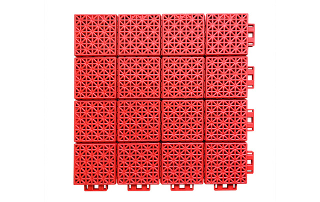 Installed 300×300×13mm soft connection PP interlocking sports tiles on an indoor basketball court or multi-sport venue floor, showing full-coverage large-area modular installation with consistent different-sized block surface pattern, uniform joint alignment, and no surface buckling or warping across the court area.