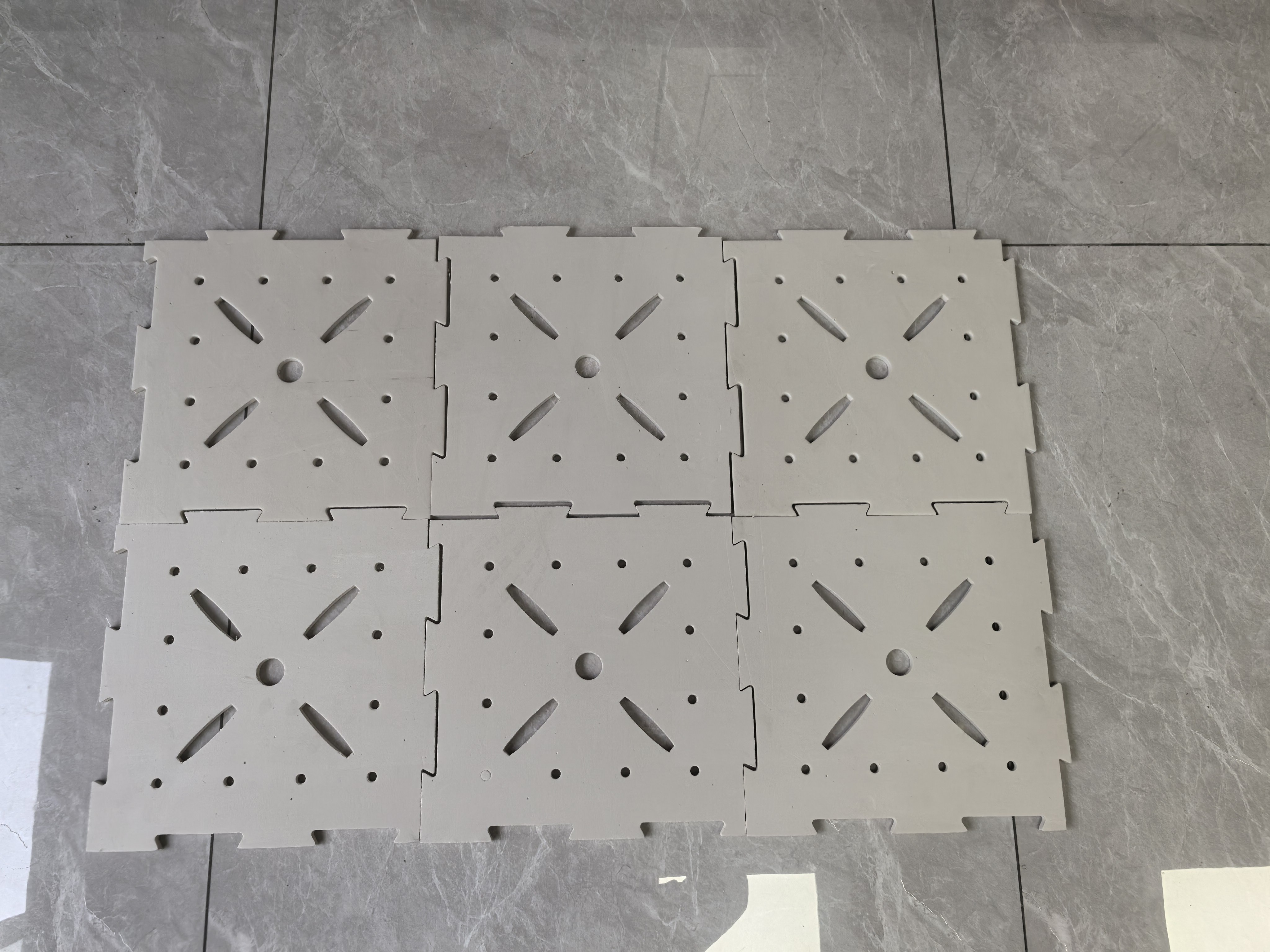 Installed 10mm LDPE shock pad rolled out as a continuous subsurface underlay beneath an artificial turf system on a sports field, showing the waterproof closed-cell LDPE material surface, subbase coverage, and the underlay's position in the synthetic turf system stack below the turf backing for football field, rugby field, or multi-sport synthetic turf installation.