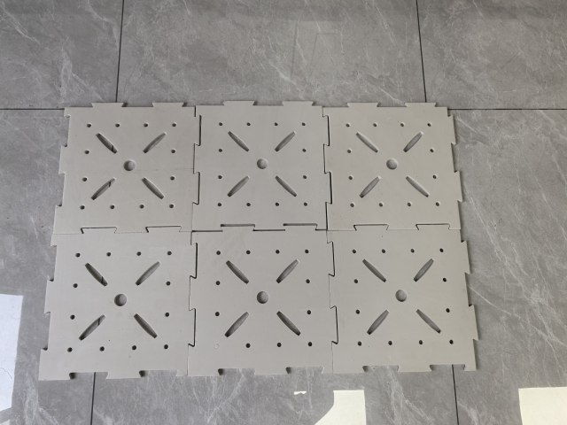 Installed 10mm LDPE shock pad rolled out as a continuous subsurface underlay beneath an artificial turf system on a sports field, showing the waterproof closed-cell LDPE material surface, subbase coverage, and the underlay's position in the synthetic turf system stack below the turf backing for football field, rugby field, or multi-sport synthetic turf installation.