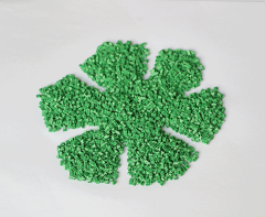 Side-by-side comparison of five-leaf type and snowflake type TPE eco-friendly artificial grass infill granules showing the distinct geometric profiles of the two granule shape variants, illustrating the different interlocking and packing characteristics relevant to synthetic turf system infill specification.
