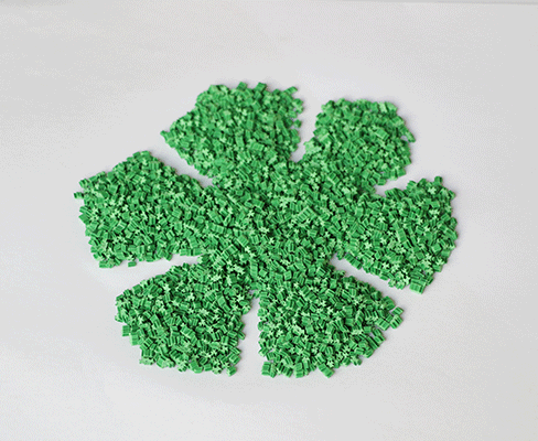 Side-by-side comparison of five-leaf type and snowflake type TPE eco-friendly artificial grass infill granules showing the distinct geometric profiles of the two granule shape variants, illustrating the different interlocking and packing characteristics relevant to synthetic turf system infill specification.
