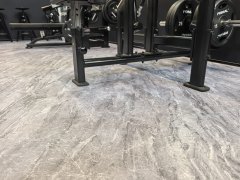 Copolymer surface rubber floor tile in commercial flooring project deployment showing installed tile array, compact surface appearance, customizable pattern design, and integration with commercial facility floor area